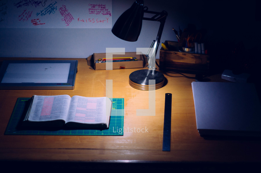 An open Bible on a desk. 