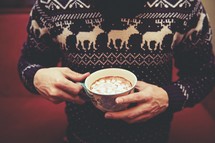 man holding a mug of hot chocolate 