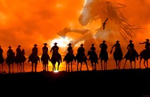 Roundup Time! A group of cowboys on horseback silhouetted against an Arizona Sunset riding off into the sunset rounding up horses showing the spirit of the wild west where horses and cowboys tamed the wild frontier. Copyright Rick Short, all rights reserved.  