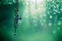 cross necklace and a green background
