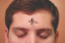 man with a cross of Ashes on his forehead 