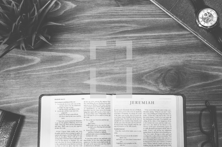 Jeremiah, open Bible, Bible, pages, reading glasses, wood table 