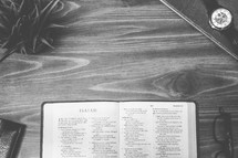 Isaiah, open Bible, Bible, pages, reading glasses, wood table 