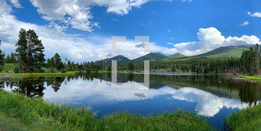 sky reflecting on a high mountain lake in spring. Rocky Mountain National Park, Colorado