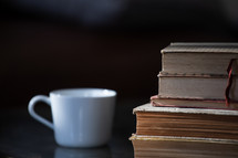 coffee cup and a stack of books 