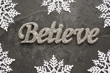 snowflake border on gray and word believe 
