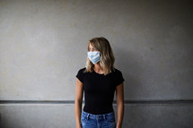 a young woman posing wearing a face mask 