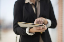 a career woman carrying an iPad 
