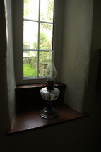 oil lamp in a window 