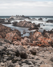 ocean water around rocks on a shore 