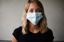 a young woman posing wearing a face mask 