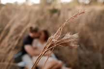 couple hugging in a field 