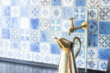 brass faucet and pitcher 