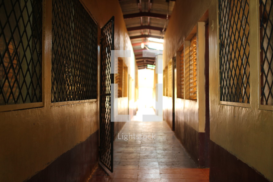 gate and barred windows in a long hall 