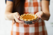 a woman holding a pie 