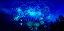fireworks bursting in the nights sky in blue 