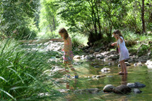 girls on stones in a stream 