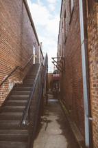 steps to the back of a building in an alley 