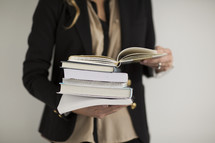 a student holding a stack of books 
