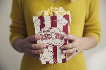 woman holding popcorn 