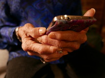 elderly woman holding a cellphone 