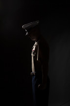Marine soldier in uniform, bowing his head in prayer.