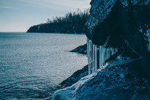 icicles on rock by a shore 