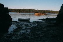 boat in shallow water along a shore 
