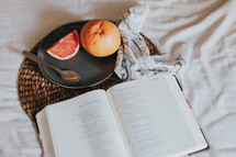 open Bible and breakfast in bed 