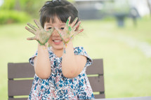 girl with paint on her hands 