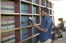 a man checking out a book at a library 