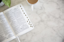 open Bible on a marble countertop 