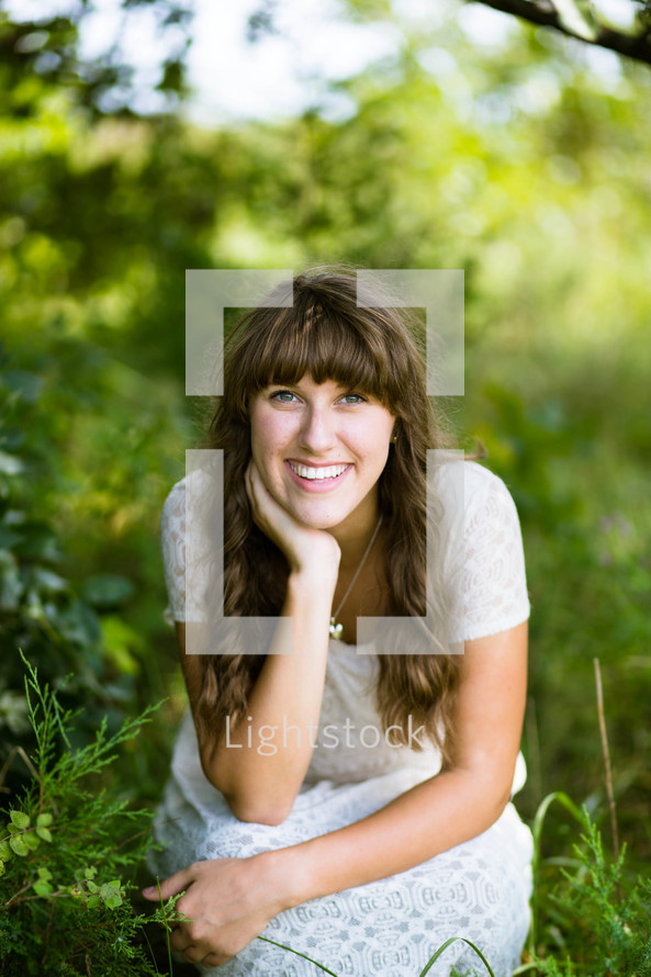 a woman with bangs smiling outdoors 