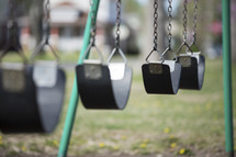 empty swings on a playground 