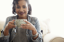 An African American woman holding a cup of tea