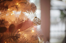 close up of a gold ornament on a beautifully decorated tree