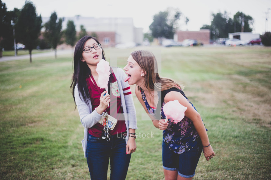 teen girls eating cotton candy 