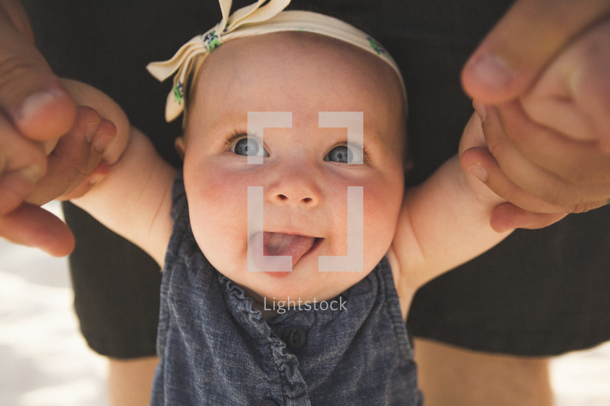 infant girl sticking her tongue out 
