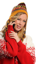 A woman in winter clothes talking on a cell phone.