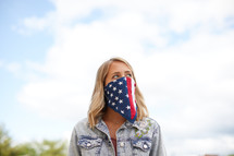 a young woman wearing an American flag bandana 