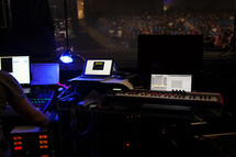 man backstage at a soundboard 