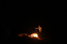 man kindling a fire 