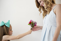 daughter giving mom flowers.