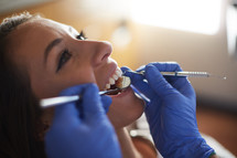 a woman at the dentist getting a dental exam 