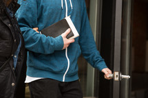 a couple walking carrying a Bible 