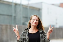 teen girl flashing peace signs 