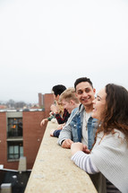 group of teens looking over a railing on a parking deck 