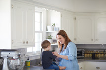 a mother with her toddler son in the kitchen 