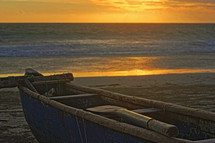 beached boat at sunset 