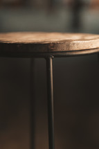 Stool close up photo of a wooden and metal seat, vintage seating chair